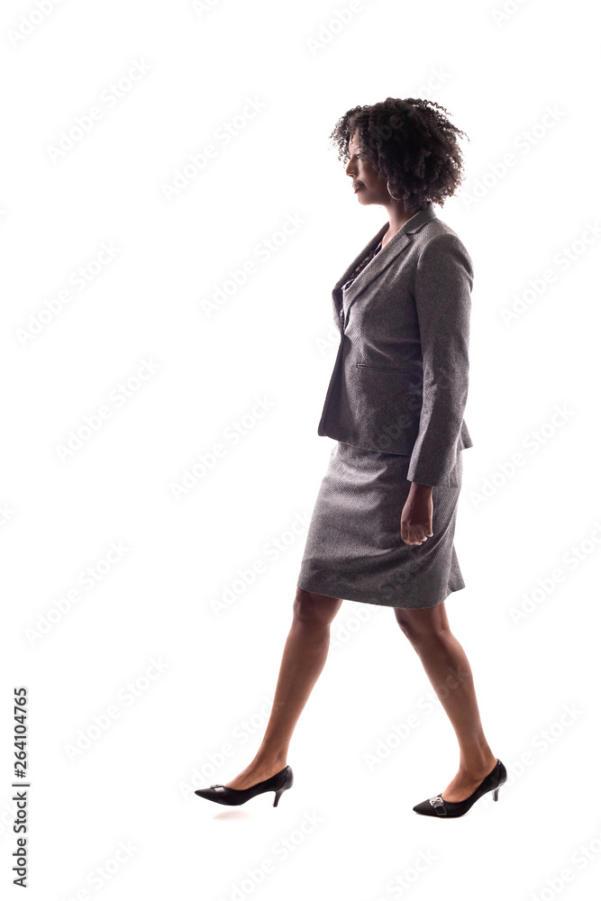 Side View of a Black Businesswoman walking in side view isolated on a ...