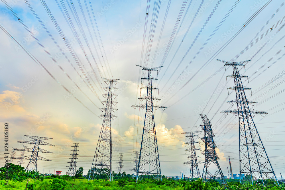 Large high voltage towers under the blue sky white clouds