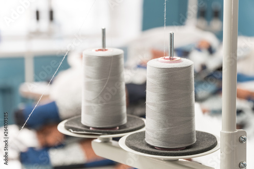 threads. shop tailoring. apparel manufacturing. thread on the sewing machine stand
