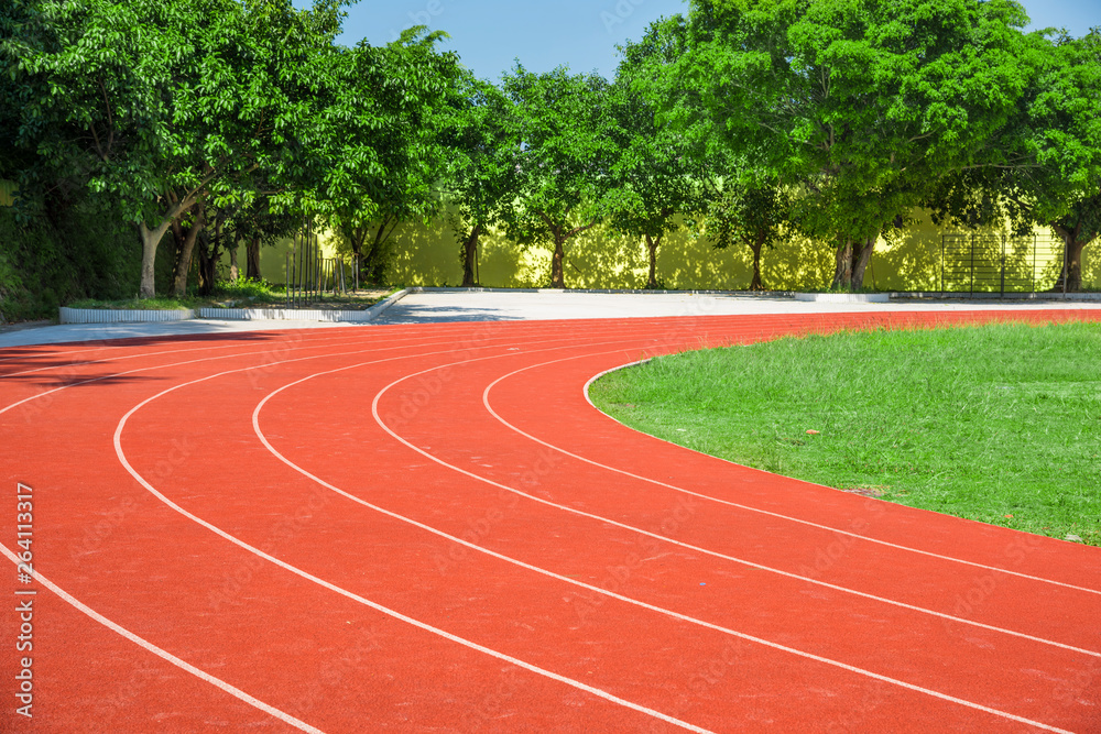 Outdoor track and field stadium runway under the blue sky. Outdoor track and field stadium runway under the blue sky.