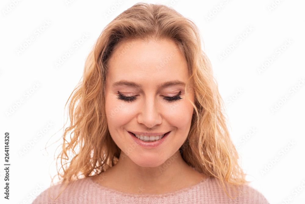 Close up portrait of a positive smiling young woman wearing a pink dress .with closed eyes on white background. Dreamer Close up portrait of a positive smiling young woman wearing a pink dress .with closed eyes on white background. Dreamer