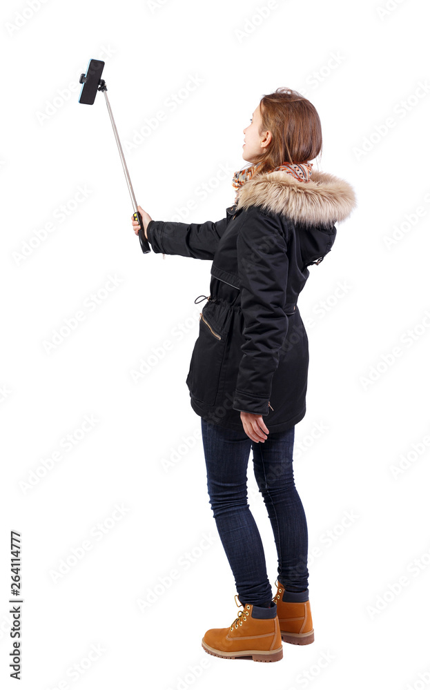 back view of standing young beautiful girl in winter jacket wit back view of standing young beautiful girl in winter jacket wit