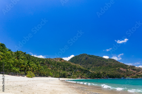 Aninuan beach, Puerto Galera, Oriental Mindoro in the Philippines, white sand, coconut trees and turquoise waters, landscape view.