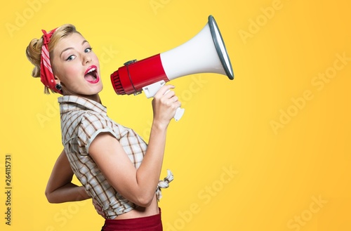 Portrait of woman holding megaphone, dressed in pin-up style photo