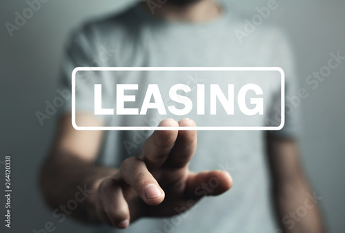 Man hand touch in Leasing text. Business