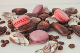  Macaroons, coffee beans and chocolate shells on a white background. Sweets and coffee on a white background