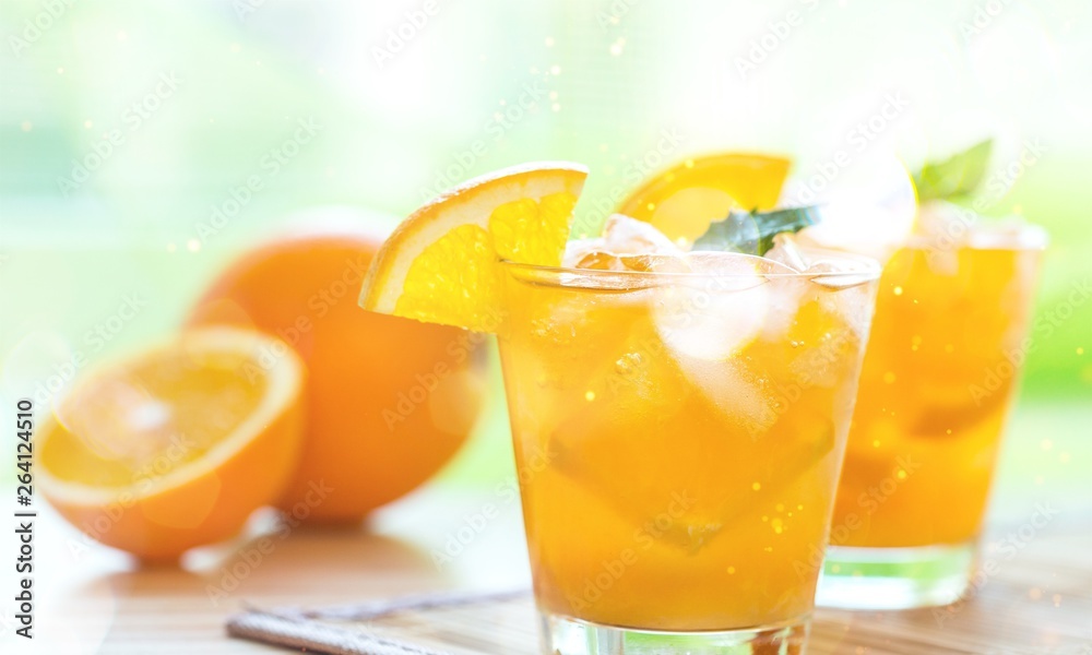 Close-up of fresh orange drinks on table background Close-up of fresh orange drinks on table background