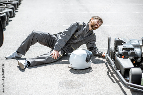 Foto Racer lying on the track with serious injury after the accident during the race