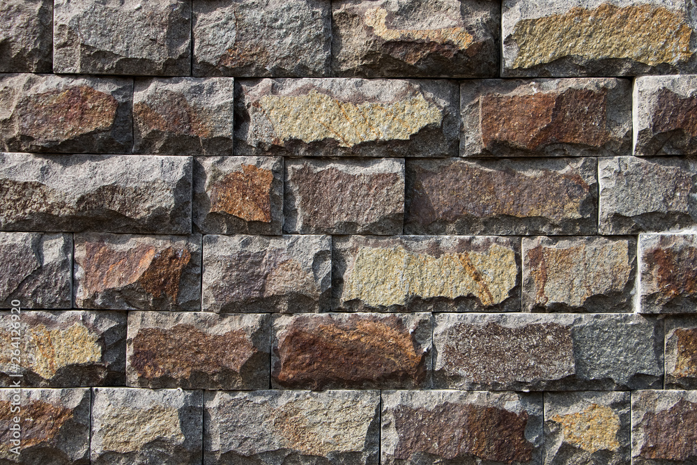 Naklejka premium Background, texture, masonry from a multi-colored natural stone