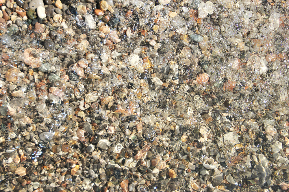 Small pebbles pebbles under the water surface photo background Small pebbles pebbles under the water surface photo background