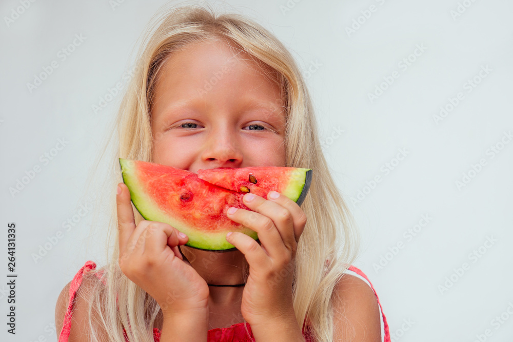 Young little blonde girl tanned skin drinking a homemade detox juice healthy eating.papaya, pineapple, dragon fruit, orange on a white table next to a blender.tropical vacation in Bali Young little blonde girl tanned skin drinking a homemade detox juice healthy eating.papaya, pineapple, dragon fruit, orange on a white table next to a blender.tropical vacation in Bali