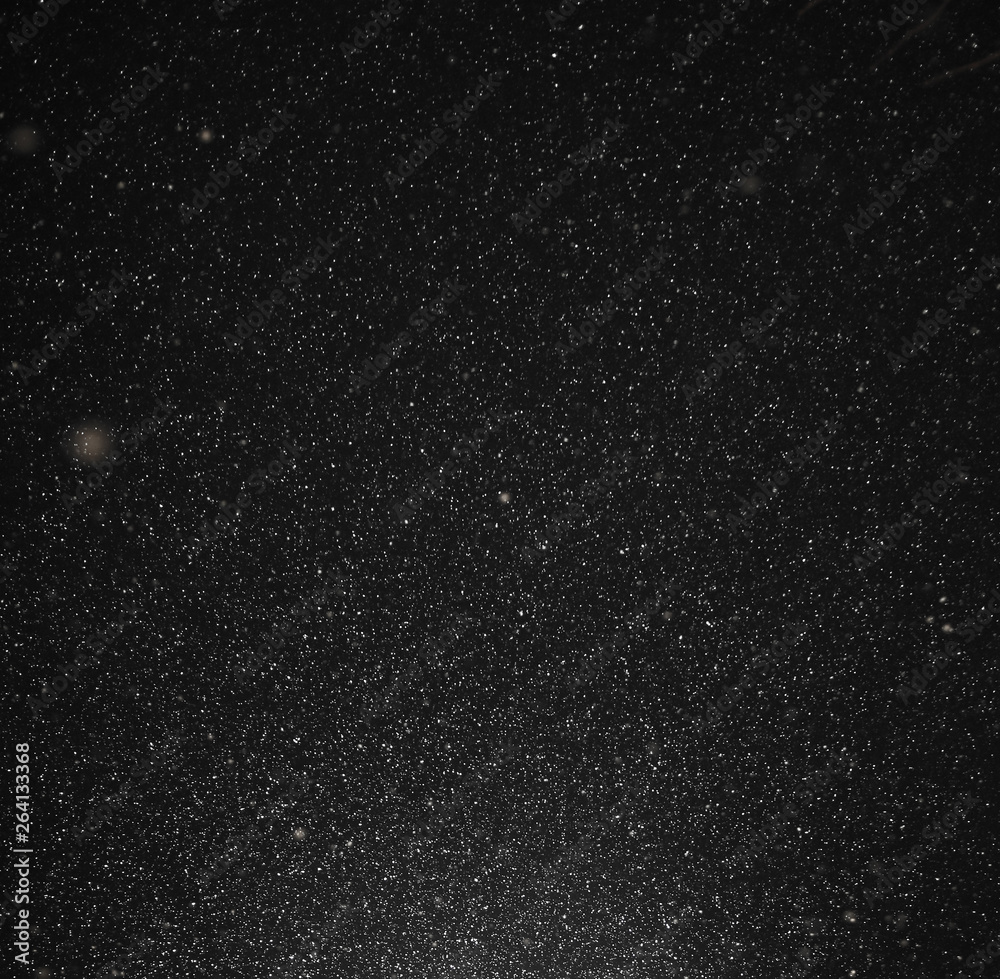 Snow flies in the sky at night as a background Snow flies in the sky at night as a background