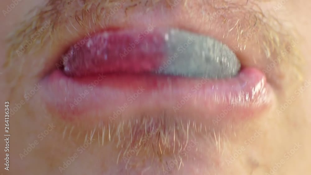 mouth of an adult male who eats a bright piece of sweets.healthy eating concept.excessive consumption of sweets.closeup.macro shoot.shallow depth of field mouth of an adult male who eats a bright piece of sweets.healthy eating concept.excessive consumption of sweets.closeup.macro shoot.shallow depth of field