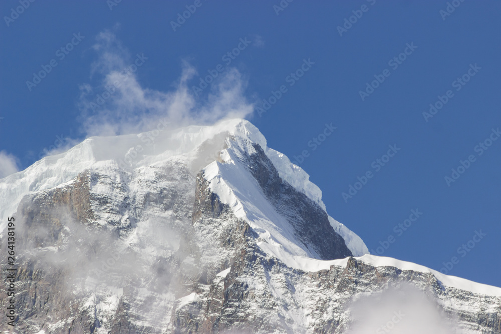giant ice peak shrouded in clouds with huge chunks of snow, Mountain climbing