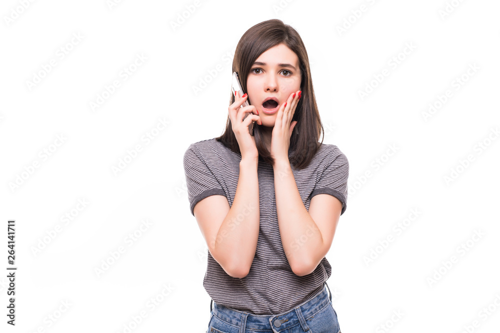 Close up portrait of shocked woman talking to somebody on the phone isolated on white background Close up portrait of shocked woman talking to somebody on the phone isolated on white background