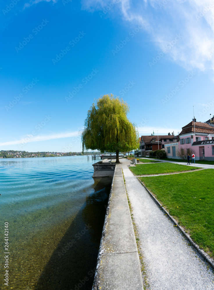 tourists walk along the idyllic lakeshore in Steckborn on Lake Constance