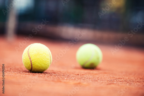 Close up of tennis balls on tennis court. Sport concept © NDABCREATIVITY