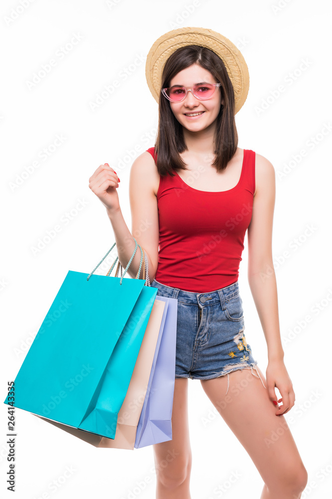 Colourful shopping vibes. Full length portraits of smiling brunette woman in hat and bright clothes with shopping bags isolalted on white background Colourful shopping vibes. Full length portraits of smiling brunette woman in hat and bright clothes with shopping bags isolalted on white background