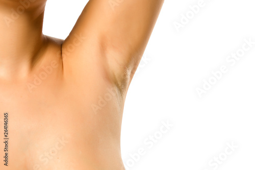 woman shows her smooth armpit on white background