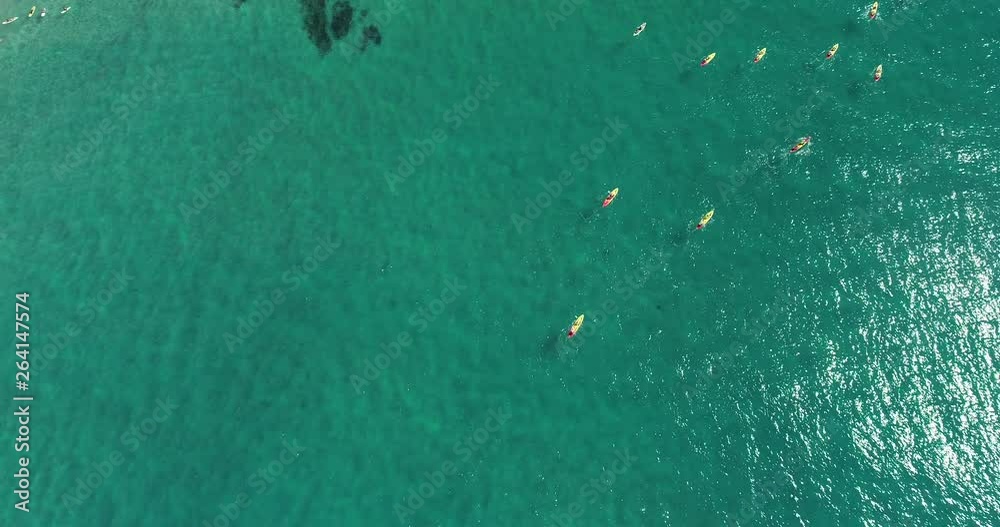 Group of canoe and kayak cursing through a nice and clear warm tropical water. Aerial footage of people kayaking and canoeing. Group of canoe and kayak cursing through a nice and clear warm tropical water. Aerial footage of people kayaking and canoeing.