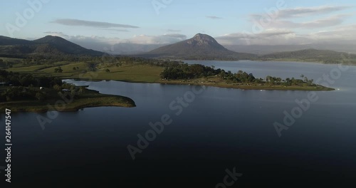 Morning light over a lake and mountain in a background. Camping paradise in the countryside with a lake and hills to explore. Moogerah, Queensland. photo