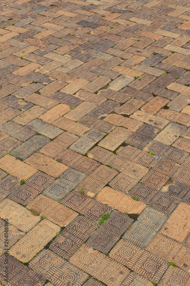 Fototapeta premium Diagonal pattern background of decorative brick pavers, vertical aspect