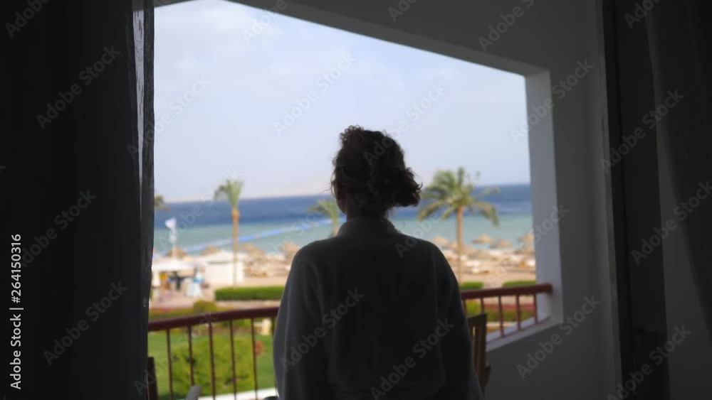 Happy Woman With Arms Wide Open Looking On The Ocean From Resort Balcony. Happy Woman With Arms Wide Open Looking On The Ocean From Resort Balcony.