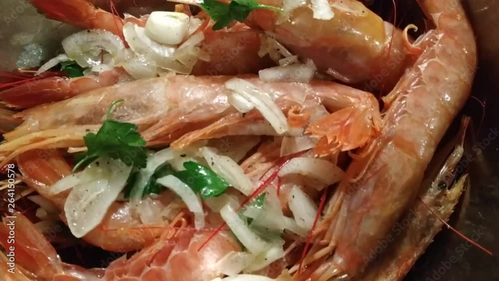 Appetizing close-up on pots filled with large Argentine prawns seasoned with onion, parsley and pepper, ready for cooking. In the background visible flour anchovies for frying. 30 Fps Appetizing close-up on pots filled with large Argentine prawns seasoned with onion, parsley and pepper, ready for cooking. In the background visible flour anchovies for frying. 30 Fps