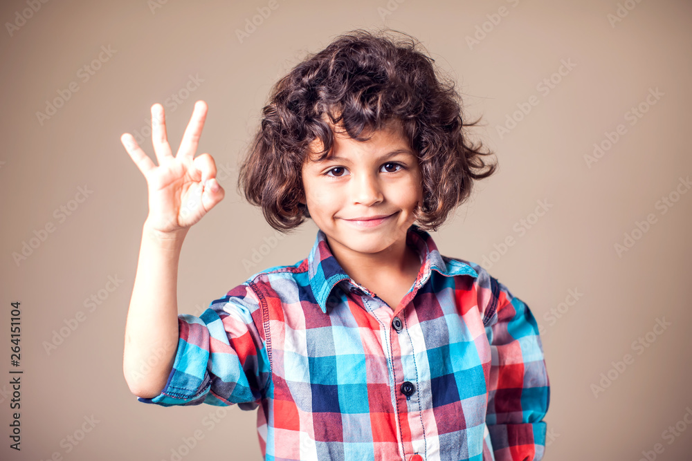 childhood, fashion, advertisement and people concept - happy boy in white t-shirt and jeans showing ok hand sign