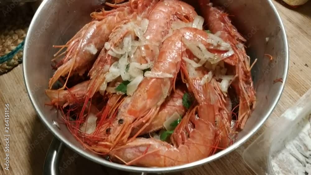 Appetizing close-up on pots filled with large Argentine prawns seasoned with onion, parsley and pepper, ready for cooking. In the background visible flour anchovies for frying. 30 Fps Appetizing close-up on pots filled with large Argentine prawns seasoned with onion, parsley and pepper, ready for cooking. In the background visible flour anchovies for frying. 30 Fps