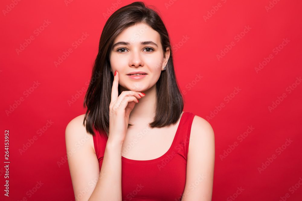 Attractive pretty young woman isolated on red background Attractive pretty young woman isolated on red background