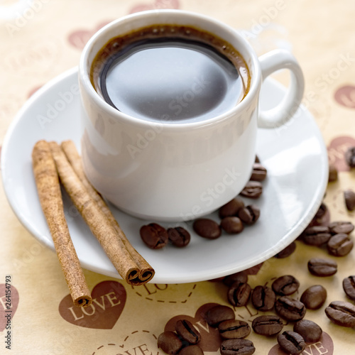 a Cup of natural coffee beans and cinnamon
