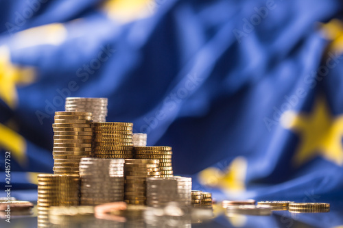 Towers with euro coins and flag of European Union in the background photo