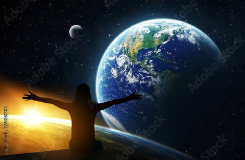 Back view of woman with hands up looking at planets   Borderless communication conceptElements of this image are furnished by NASA.