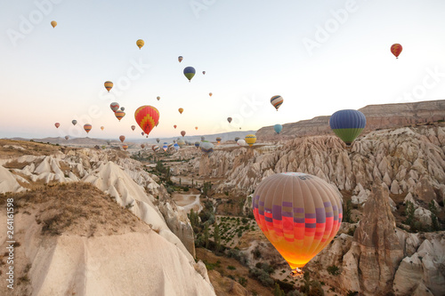 Hot air balloons flying over rock landscape at Cappadocia