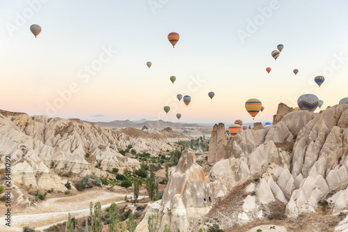 Hot air balloons flying over rock landscape at Cappadocia