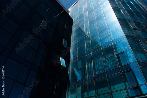 modern multi-story building with mirrored walls on a sunny clear day