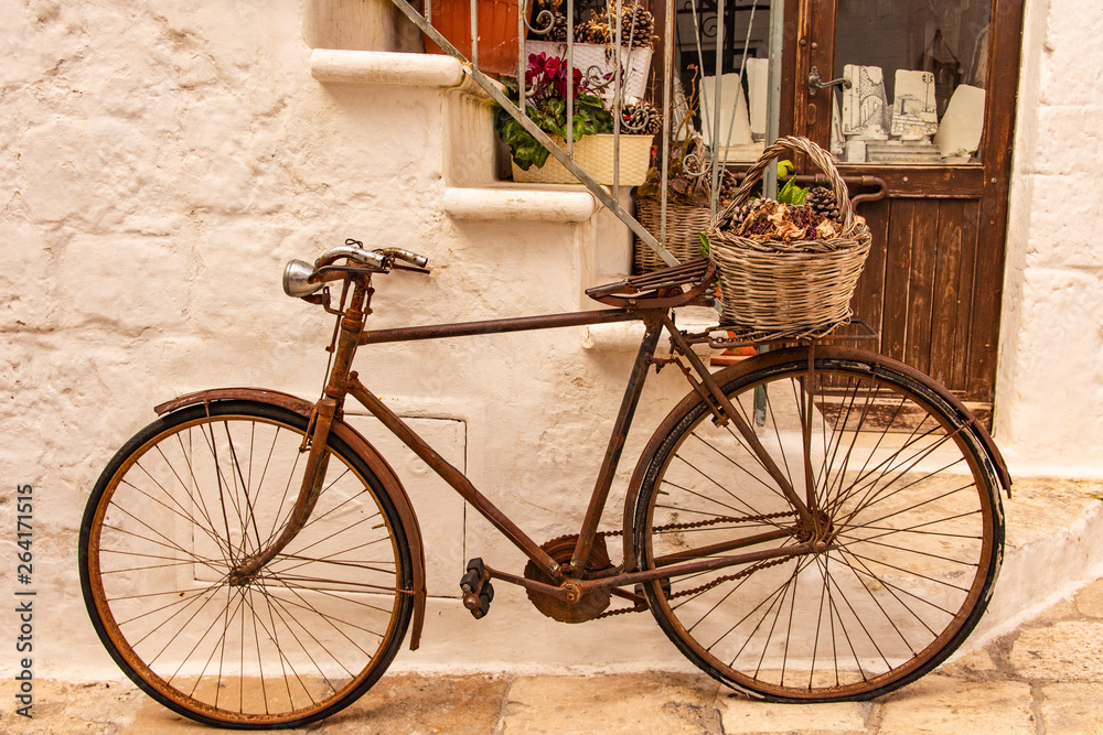 Italy, Ostuni, old bicycle leaning against the wall, for tourists.