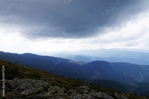 Mountain landscape with green grass against the sky. Panoramic view of the cliffs without people. Wildlife on hills and altitude.
