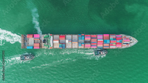 Aerial top view tug boat drag container ship to sea port for logistics, import export, shipping or transportation.