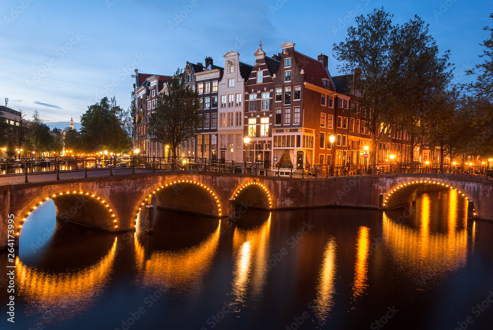 light up bridges over canals of Amsterdam at blue hour