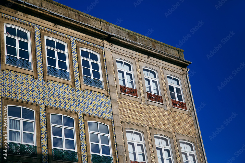 old colorful building and facades against the blue sky in the historic center of Porto, Portugal