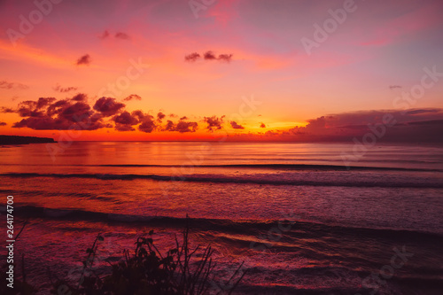 Ocean with waves and bright sunset or sunrise. © artifirsov