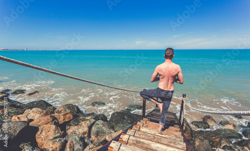 Caucasian man in jeans practice pose yoga stair step © Juanrastock