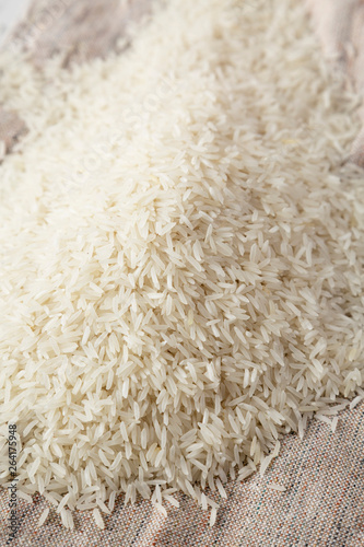 Dry white rice basmati on cloth, side view. Close-up.