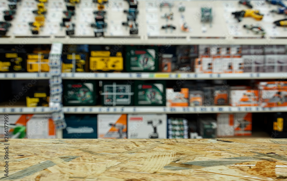 Shop for selling electric tools. Drills, screwdrivers, electric saws, grinder. Defocused, blurred image.