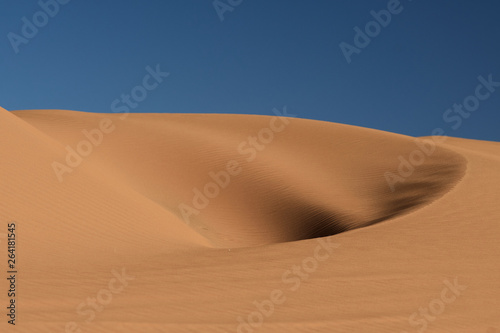 hole in the dune under the blue sky