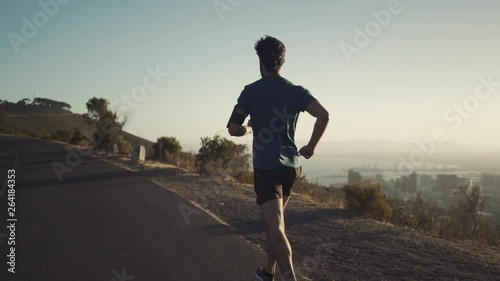 Athletic young man running on the road