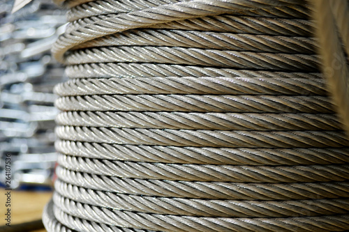 Clean new steel cable, steel wire or steel rope wound on a bobbin standing on a shelf