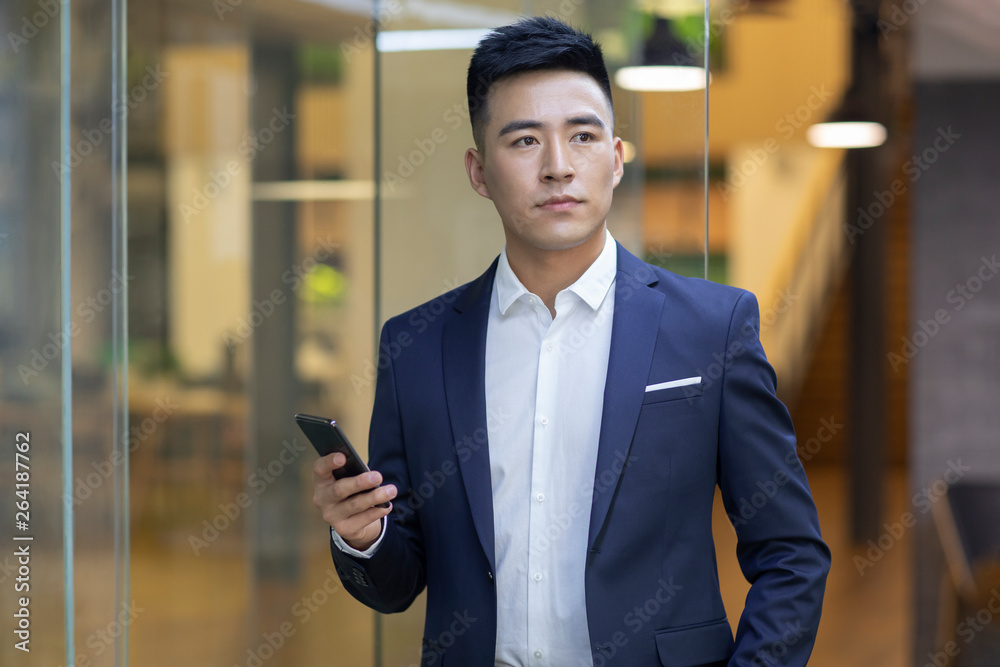 Confident young businessman using smart phone Confident young businessman using smart phone